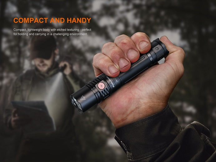 Person holding the Fenix PD36R V2.0 compact rechargeable tactical flashlight, showcasing its portable and ergonomic design