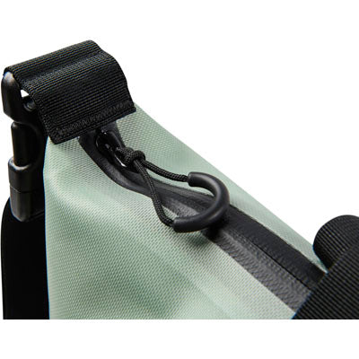 Close-up of a green bag with black straps and buckle on a white background