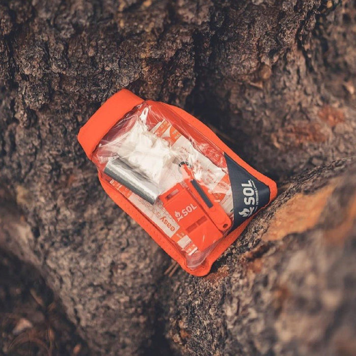 Waterproof emergency survival kit with fire starters and compass


