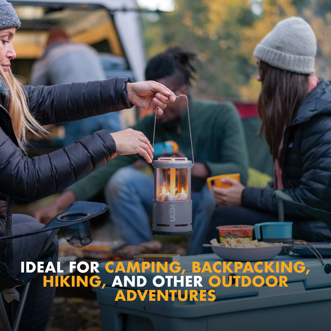 UCO candle lantern glowing in a tent campsite at night using 15-hour candles