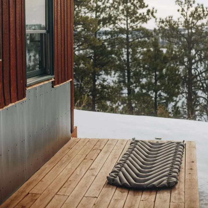 A person inflating the Static V Luxe sleeping pad with 20-30 breaths, highlighting its easy inflation process.