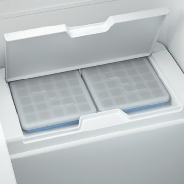 Two removable ice trays with snap-on silicon lids from the Dometic CFX3 55IM cooler, designed to prevent water spillage and ensure ice production even when the cooler is set to refrigeration mode