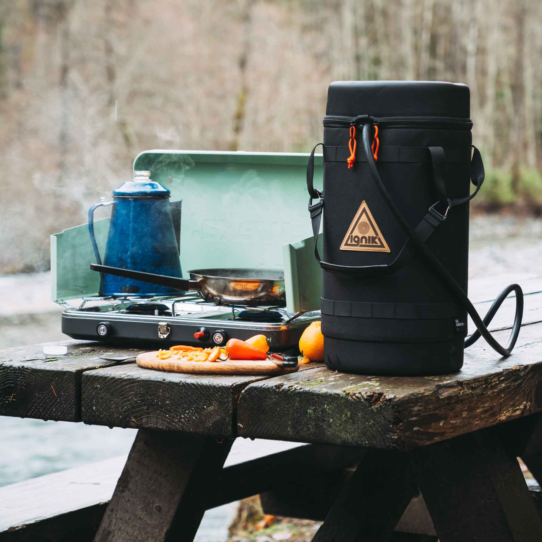 Propane tank in dual zip-top case with detachable carrying handle and Molle stitching.