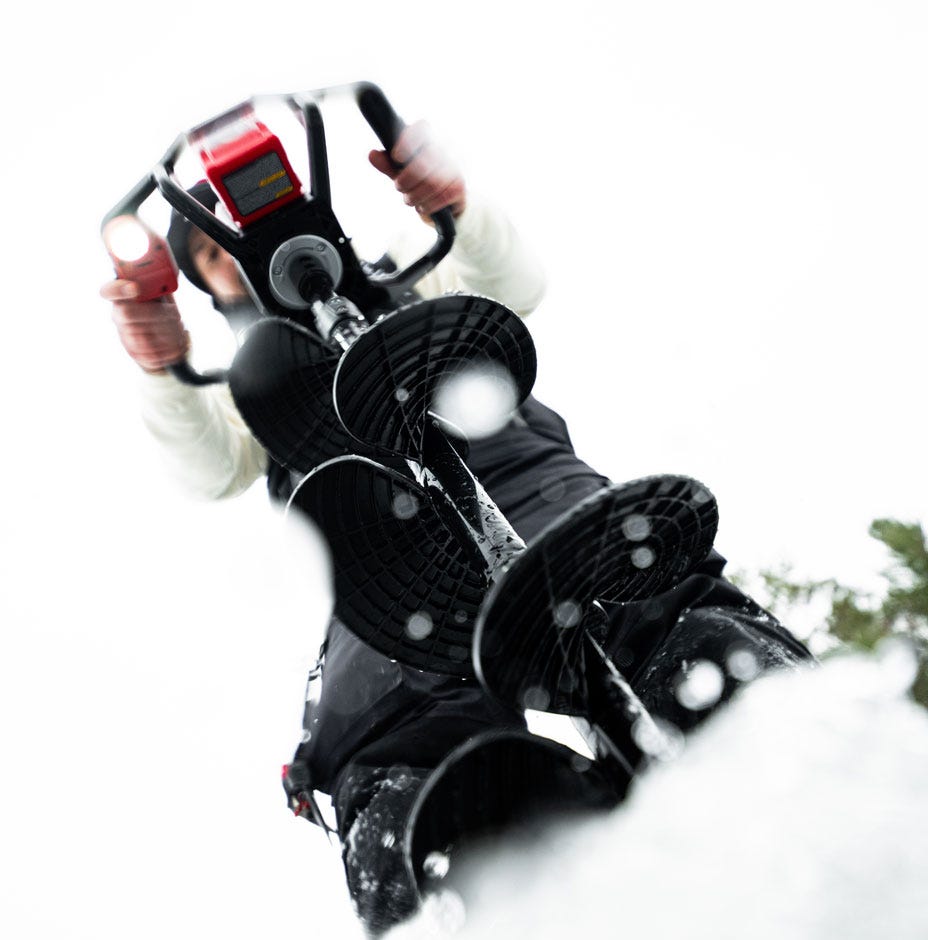 Person skiing with a helmet and goggles on a snowy background
