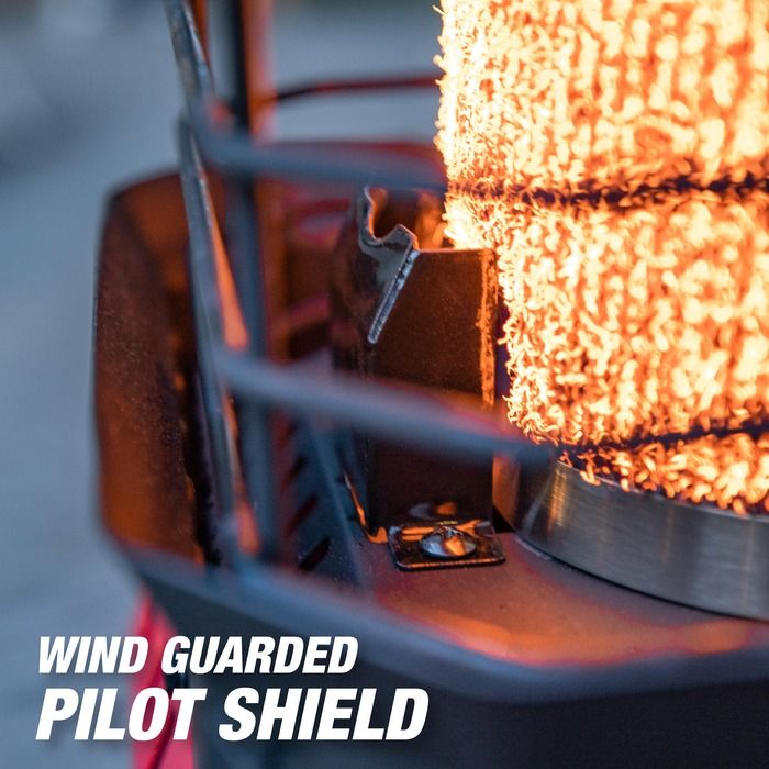 Close-up of a wind guarded pilot shield with sparks flying, indicating use in a high-temperature environment.