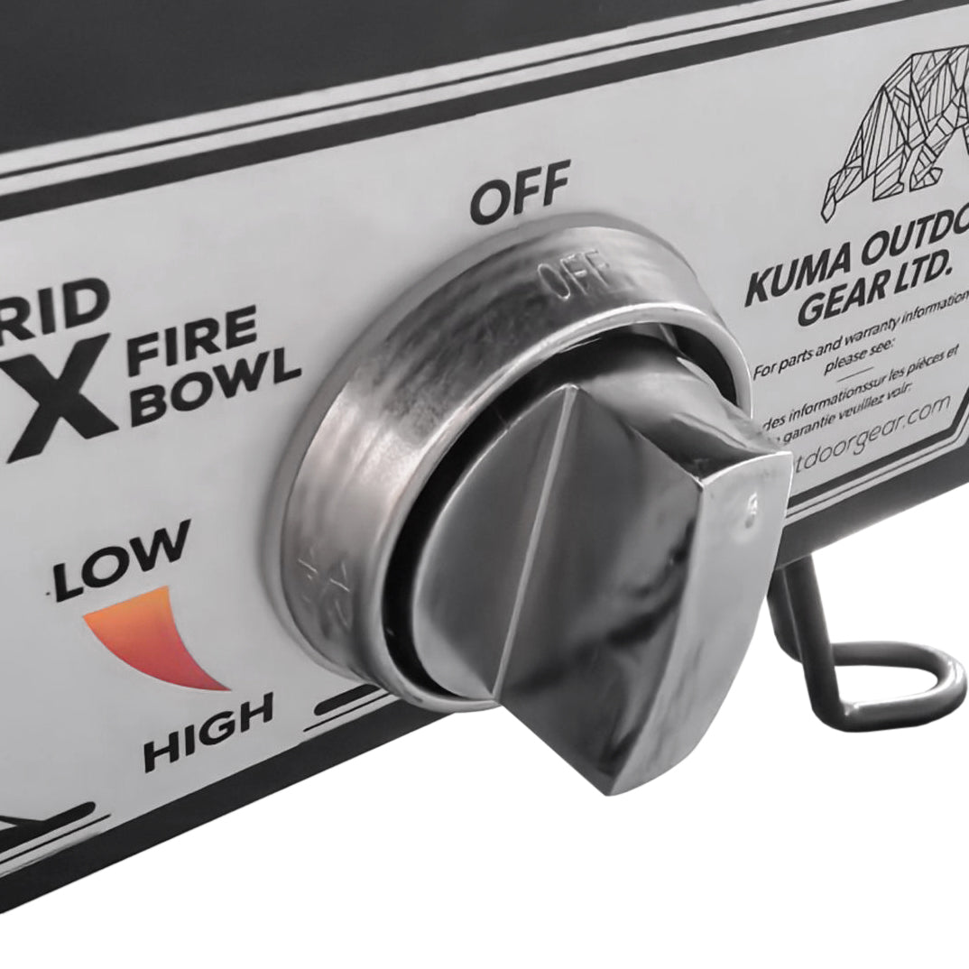 The hexagonal fire pit lit up, emitting a warm flame, surrounded by black lava rocks. It’s placed outdoors, creating a cozy and inviting atmosphere.

