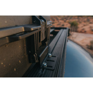 Close-up of a truck bed with a desert landscape in the background