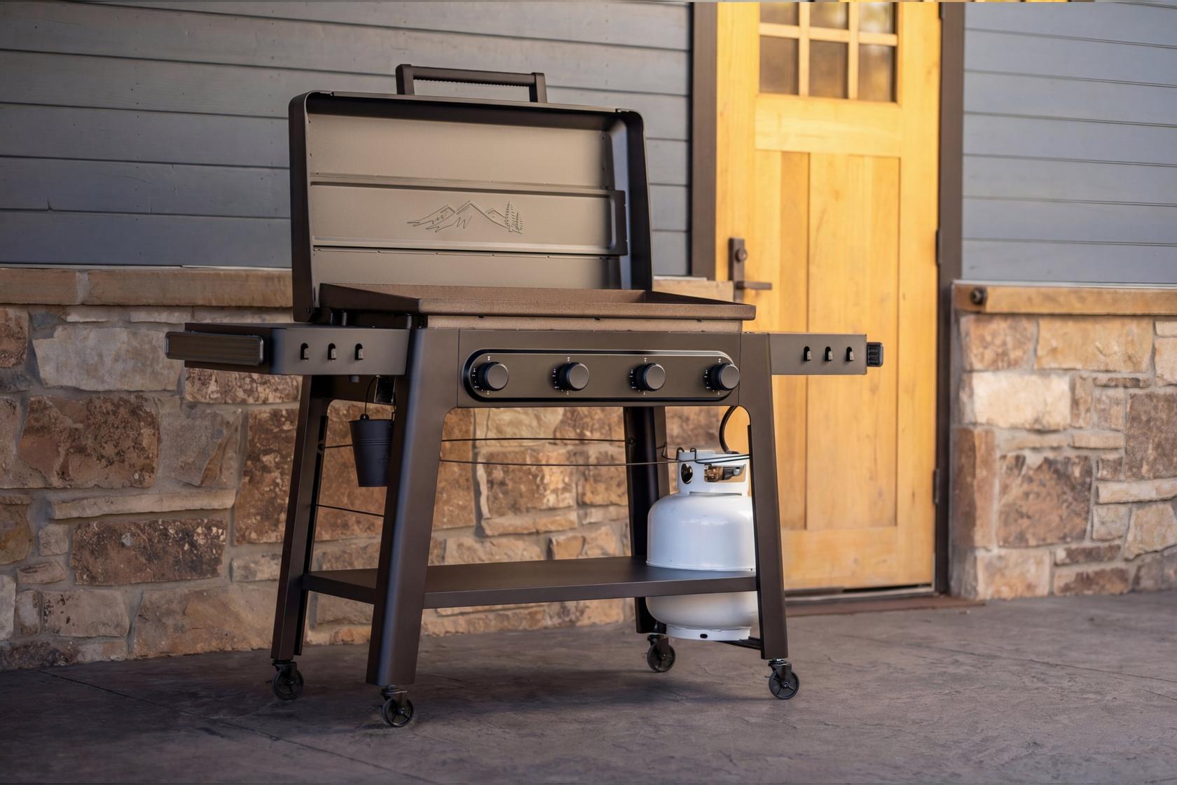 Breakfast being cooked on a Traeger Irontop 4-Burner griddle with eggs, pancakes, and bacon on the large cooking surface.