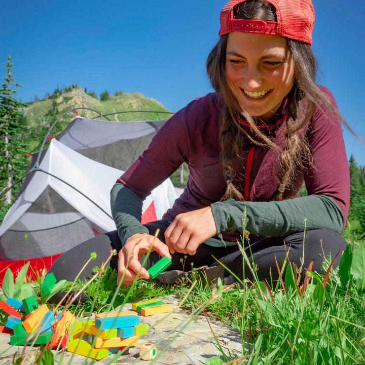 Compact tumbling tower game with dice and carry pouch